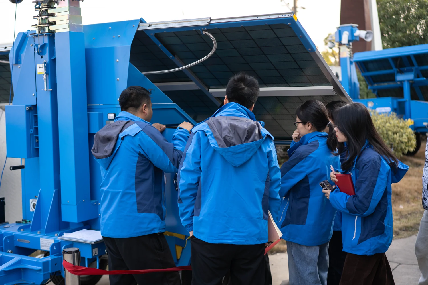 Team reviewing equipment beside an open cabinet